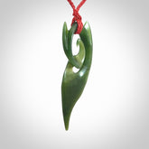 This photo shows a koru pendant carved from New Zealand Jade. The artist, Shaun Gardiner, has carved this beautifully. We provide this piece with an adjustable red cord. This is a fantastic work of art, we have one only.
